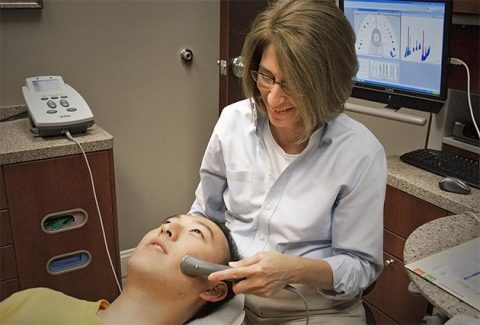 A headache patient is treated with ultrasound technology at MHRPA.